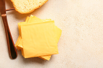 Slices of tasty processed cheese on light background