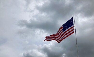 American flag against cloudy sky