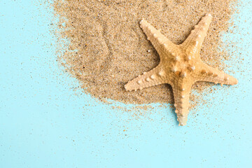 Fototapeta na wymiar Sand with starfish on blue background
