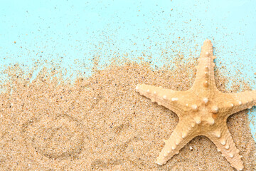 Fototapeta na wymiar Sand with starfish on blue background