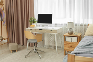 Stylish teenager's room interior with comfortable bed and workplace