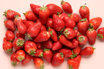 Fresh strawberries on pink background