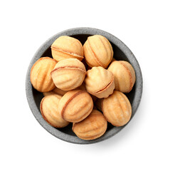 Bowl of delicious nut shaped cookies with condensed milk on white background, top view