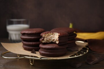 Delicious banana choco pies on wooden table, closeup