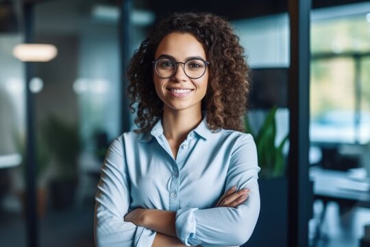 Smiling confident stylish young woman standing at the office. Young businesswoman, curly-haired lady executive business leader manager looking at camera arms crossed, generative AI