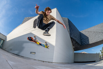 Skateboarder doing a flip trick - obrazy, fototapety, plakaty