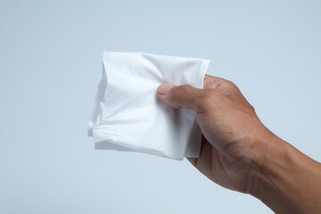 hand holding tissue on isolated white background
