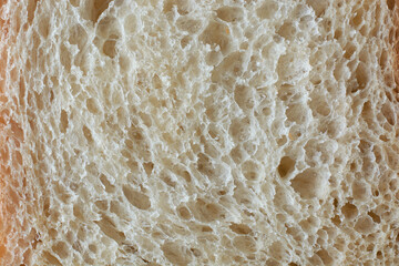 surface of white bread in full frame, popular food item in many cultures and used for making sandwiches, toast, and other dishes, lighter color and softer texture food background