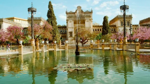 The Parque Maria Luisa, Seville, Andalusia, Spain, expansive lush park with gardens, fountains, monuments, and the impressive Plaza de Espana