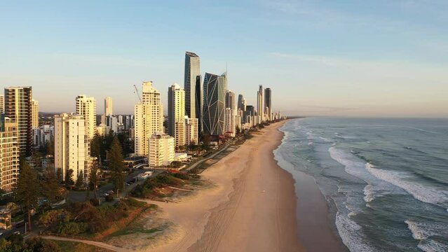 Aerial fly across Surfers Paradise coastline at sunrise. Gold Coast Australia