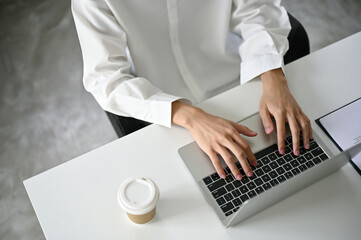 Top view of a businessman using laptop computer at a coffee shop.