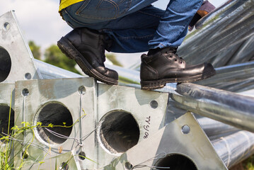 Wear safety shoes to ensure safety at work. construction workers wear safety shoes. People with...