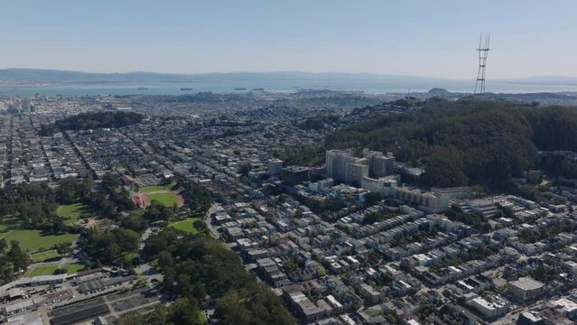 Aerial footage of urban neighbourhoods under Sutro tower. Panoramic view of metropolis. San Francisco, California, USA