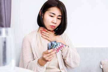 Asian Woman's Struggle with Choosing the Right Medicine for Sore Throat