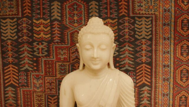 Slow motion footage slowly moving closer and closer to a buddha statue.