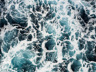 Rough dark ocean and white water surface background