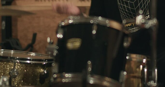 Close up energetic rock and roll tattooed drummer 4K