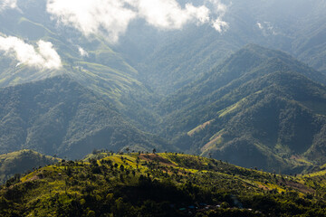Fototapeta premium Top view Landscape of Morning Mist with Mountain Layer at north of Thailand. mountain ridge and clouds in rural jungle bush forest