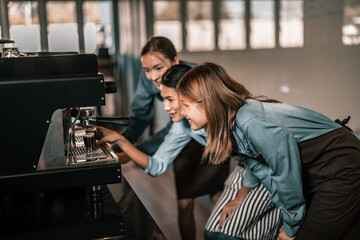 Young adult coffee makers work with skilled baristas to create menus. Using a coffee machine to...