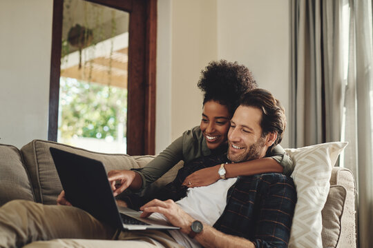 Laptop, relax and diversity with a couple watching a movie using an online subscription service for entertainment. Computer, streaming or internet with a man and woman bonding together over a video