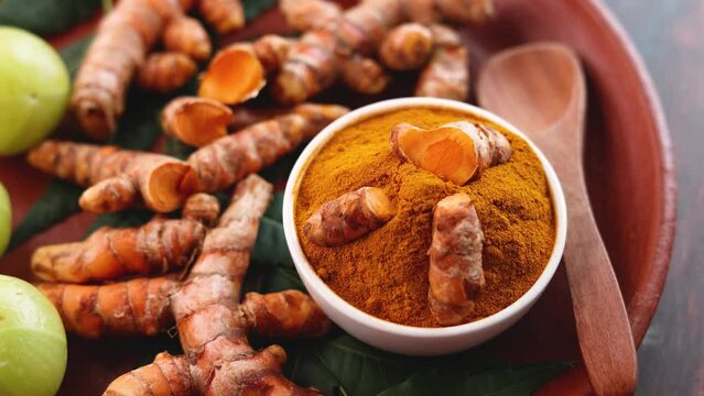Indian spices turmeric root powder stone mortar Kerala India Sri Lanka. Traditional Indian kitchen 4K slow motion video footage. Masala for curry. Antiseptic antiviral Ayurvedic medicine