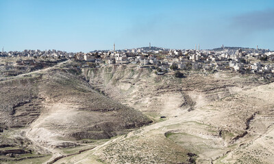 the ancient Palestinian town of al-Azariya sits in front of the towers of East Jerusalem and behind...