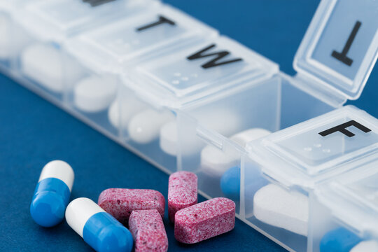 Weekly pillbox with medication, tablets and vitamins.