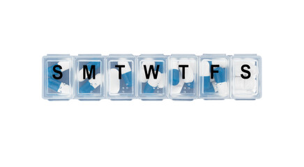 Daily pill box filled with daily doses of pills isolated on white background.