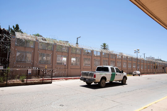 Nogales, Arizona, USA - May 29, 2022: A US Customs and Border Protection (CBP) truck drives in front of the fortified border wall.