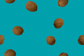 Walnuts in shells on a blue background - top view. Seamless pattern.