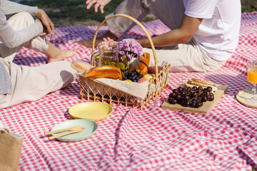 In love couple enjoying picnic time in park outdoors Picnic. happy couple relaxing together with picnic Basket