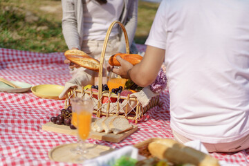 In love couple enjoying picnic time in park outdoors Picnic. happy couple relaxing together with picnic Basket
