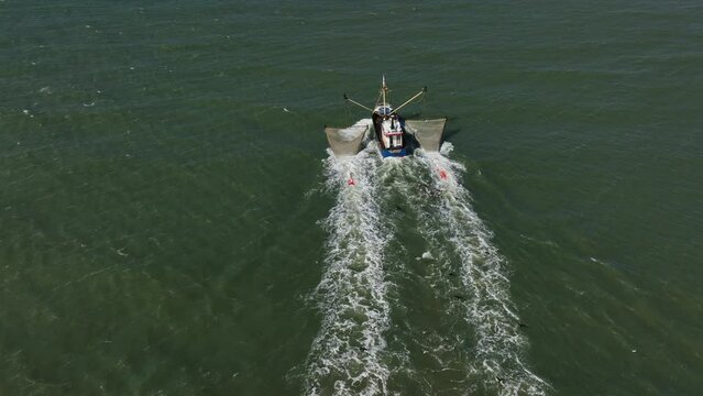 Fishing Trawler With Nets Out, Seagulls Following Behind, Slow Motion Wide Angle Aerial Shot, Tracking Behind the Boat