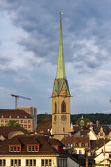 Scenic view of the old town of Zürich with church tower of Preachers's Church on a cloudy spring evening. Photo taken May 6th, 2023, Zurich, Switzerland.