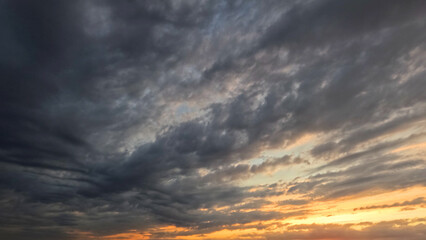 pretty dark evening sunrise skyscape with cute clouds - photo of nature