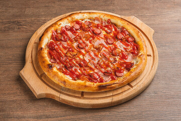 Fresh classic pizza with tomato sauce, mozzarella, spicy chorizo, bell pepper on a wooden background
