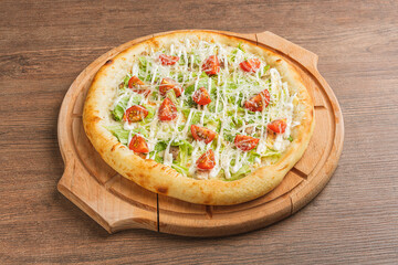 Fresh classic pizza with tomato sauce, mozzarella, spicy chorizo, bell pepper on a wooden background
