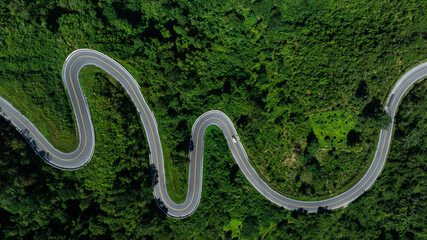 aerial view ROAD No.1081 or shape number three of winding mountain road between Pua District, Nan Province, Thailand is highlight point and landmark that tourist like to take pictures  - Powered by Adobe