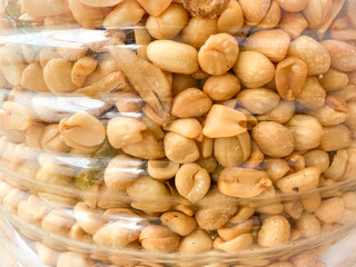 close up of fried peanuts in a jar.