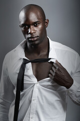 Portrait, sexy and black man with muscle, body and wellness against a dark studio background. Face,...
