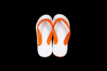 white sandals with orange rubber isolated on black background