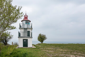 Fototapeta na wymiar Spodsbjerg lighthouse overlooking a beach meadow and the sea