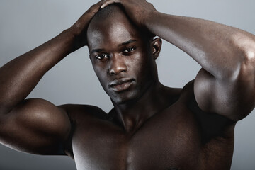 Art, aesthetic and beauty, portrait of black man on dark background with muscle and hands on head....