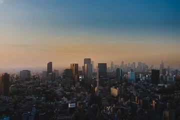 Fotobehang 春の東京の夕暮れ　ビル街と夕日 © Ryu