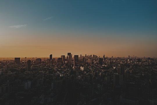 春の東京の夕暮れ　ビル街と夕日