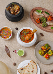 Indian restaurant main course full meal chicken curry handi non veg bbq mixed grill platter paneer barbeque mutton biryani handi tandoori roti garnish with spices top view photography