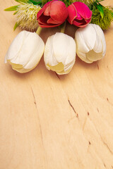Tulip flowers on wooden background with copy space. Timeless elegance with wood and tulips accents.