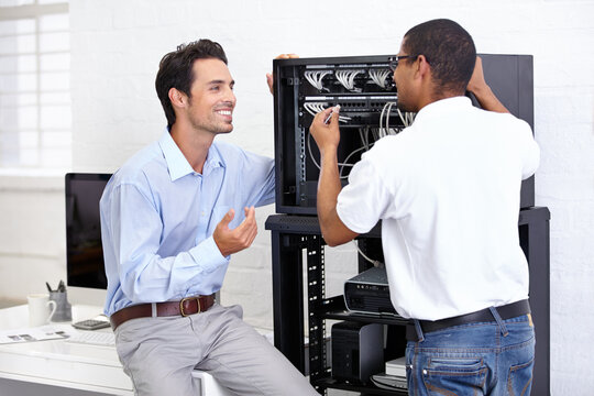 Staff, men and employees with server, internet connection and conversation for hardware update, consultation and tech support. Male people, technician and programmers with cyber security and network