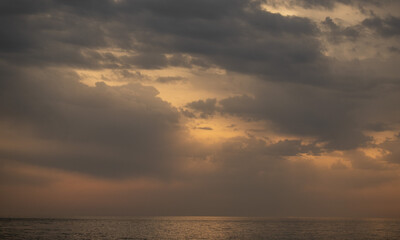 Naklejka na ściany i meble Sunset on the sea, sky with clouds, summer.