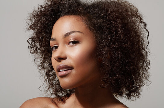 Beauty, skincare and portrait of African woman on white background with makeup, glowing skin and glamour. Natural makeup, wellness and face of beautiful, attractive and happy female model in studio
